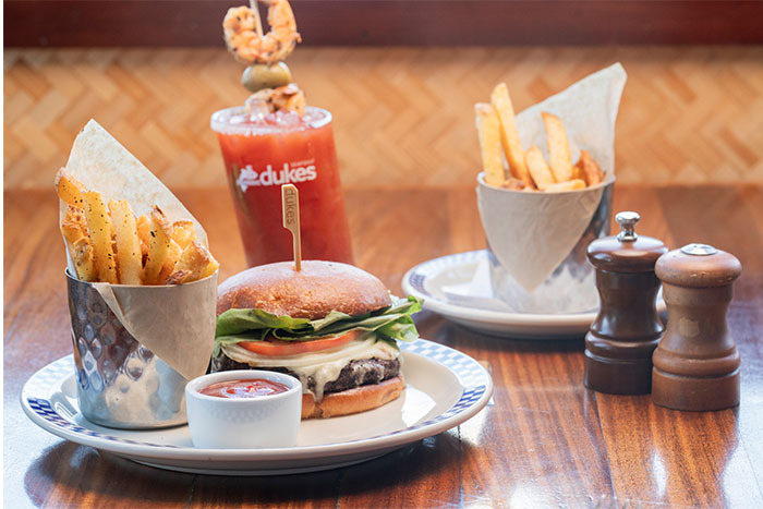 Duke's Seafood GMO-free french fries, a beef burger, and a bloody mary cocktail