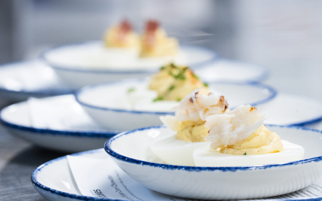 Three plates of Duke's Seafood deviled eggs from three different recipes